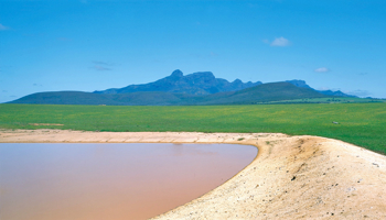 Farm dam in the south-west of WA with green fields and Stirling Ranges in the background