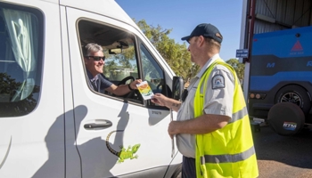 Quarantine WA border inspector taking to driver at Kimberley checkpoint