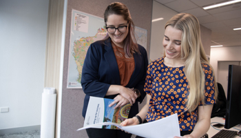 Two people reviewing documents