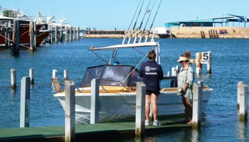 Research officer interviewing fishers at a boat ramp